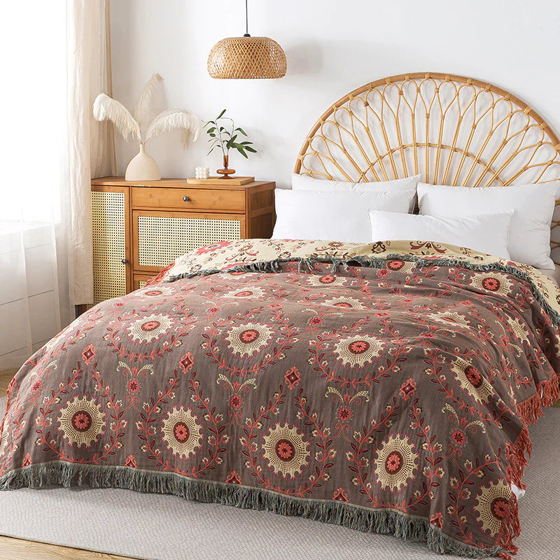 Bedroom with a bed featuring a patterned comforter, white pillows, and a wooden headboard.