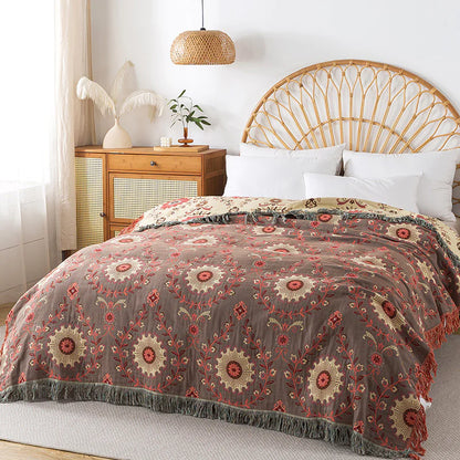Bedroom with a bed featuring a patterned comforter, white pillows, and a wooden headboard.