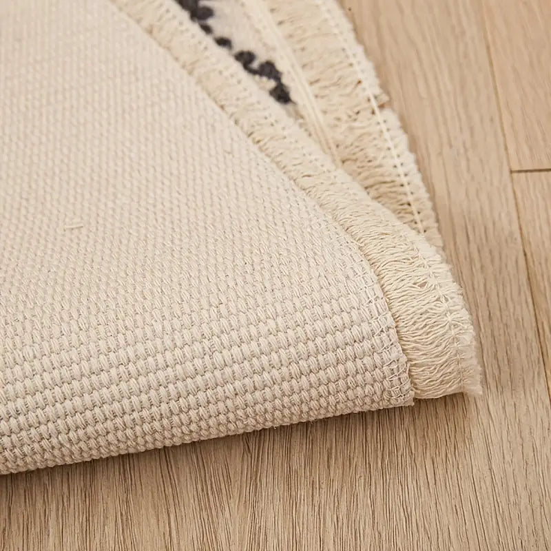 Beige textured rug on a wooden floor