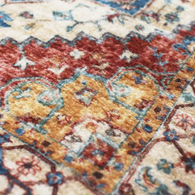Close-up of a patterned rug with red, yellow, and blue colors.