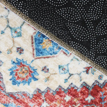 Close-up of a patterned rug with a black textured area.