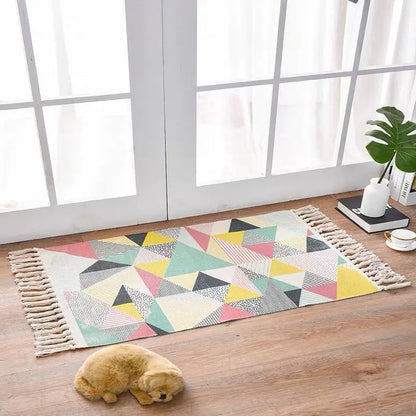 Geometric patterned rug on a wooden floor with a small dog lying on it.