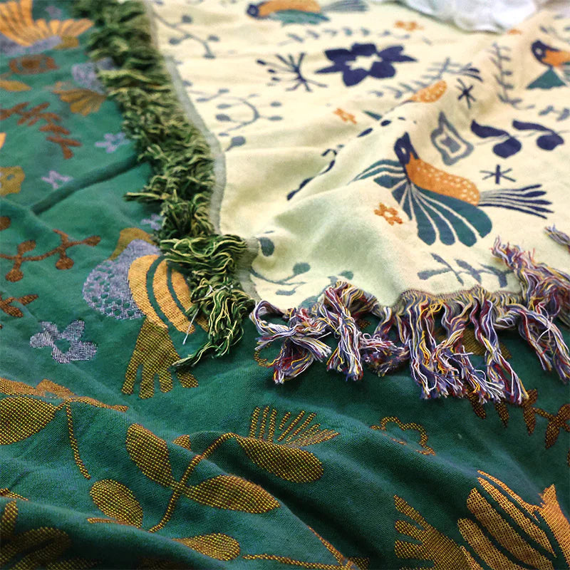 Close-up of a colorful fabric with floral patterns and tassels.