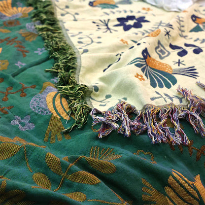 Close-up of a colorful fabric with floral patterns and tassels.