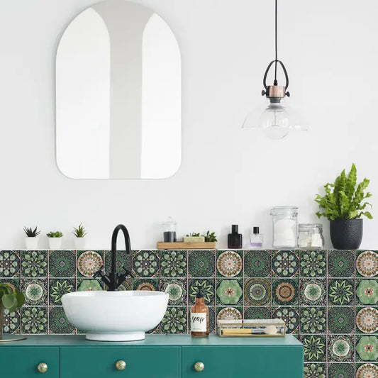 Bathroom with green tiled wall, white sink, and decorative elements.