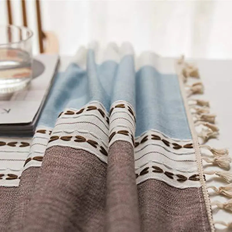 picture shows a close up of a folded tablecloth with details