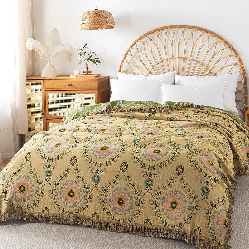 Bed with floral patterned comforter in a bedroom setting