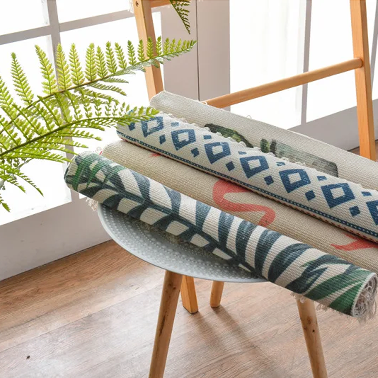 Decorative pillows with geometric patterns on a chair next to a plant