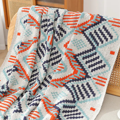 Colorful patterned blanket draped over a chair