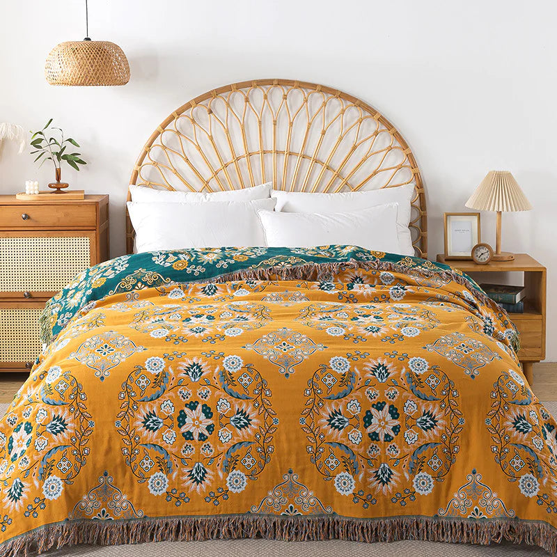 Yellow patterned comforter on a bed with a wooden headboard and side tables.