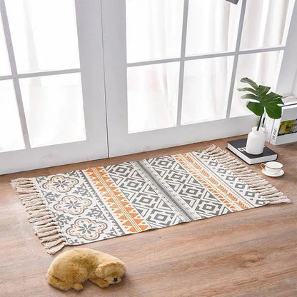 Patterned rug on a wooden floor with a small dog and decor items in the background.