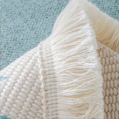 Close-up of a textured fabric with fringes on a blue background