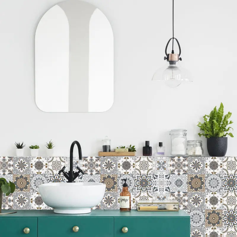 Bathroom with teal vanity, patterned tiles, and decorative elements.