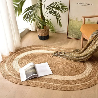 Round woven rug on a wooden floor with an open book and plant in the background